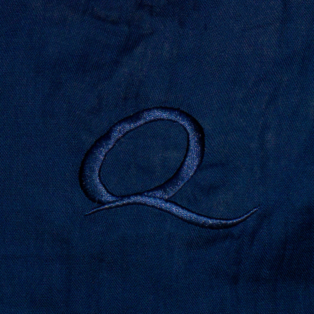 Close-up of a textured blue fabric with a logo or design.