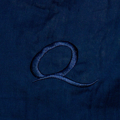 Close-up of a textured blue fabric with a logo or design.
