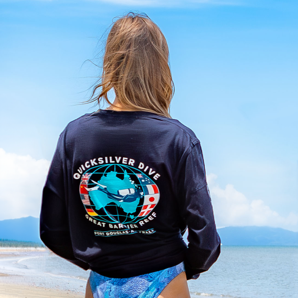 Person wearing a Quicksilver Dive shirt with a scenic background